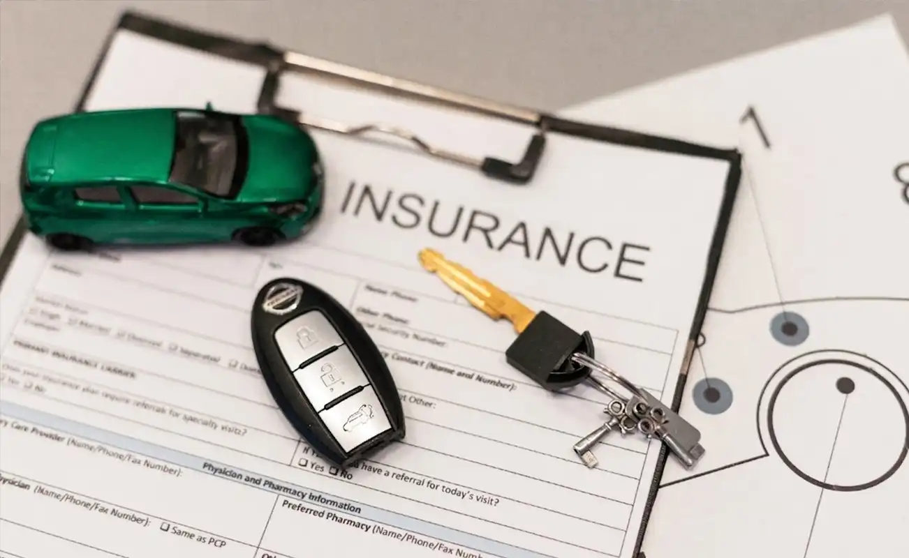 An auto insurance form with car keys